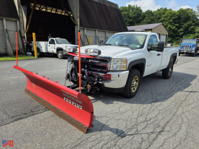 Chevrolet Silverado 3500HD 4x4 pickup with front plow attached in a lot; white extended cab with plow mounting hardware and red ProPlus snow plow blade