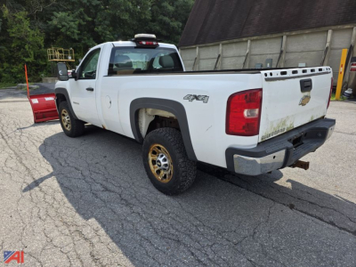 Chevrolet Silverado 3500HD Crew Cab pickup with 4x4 and plow attachment, white, rear angled view showing bed and taillights.