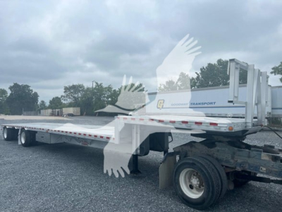 Trailer showing a long drop deck with rear ramps and a white gooseneck area; branding says Goodway Transport on side; deck appears empty.