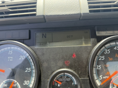 Dashboard of a Freightliner Cascadia with gear selector showing N and ambient temp 95°F; gauges and warning lights visible.