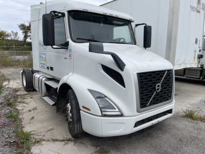 Volvo VNR day cab truck front view showing grille, large side mirrors, and Volvo emblem.