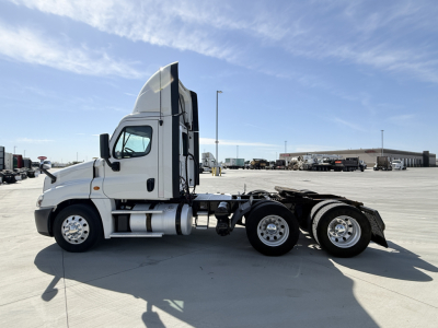 Freightliner CA12564DC tractor side view showing cab, fuel tanks, and rear chassis with dual rear axles. Text visible on listing: 2018 Freightliner CA12564DC. VIN 3AKJGEDR9JSKC7296. Stock 0632747. Category Conventional Daycab. Type Trucks. 