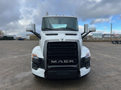 Front view of a white 2026 Mack PR64T truck cab showing bold black grille with MACK lettering, large bumper, dual mirrors, and hood vents.