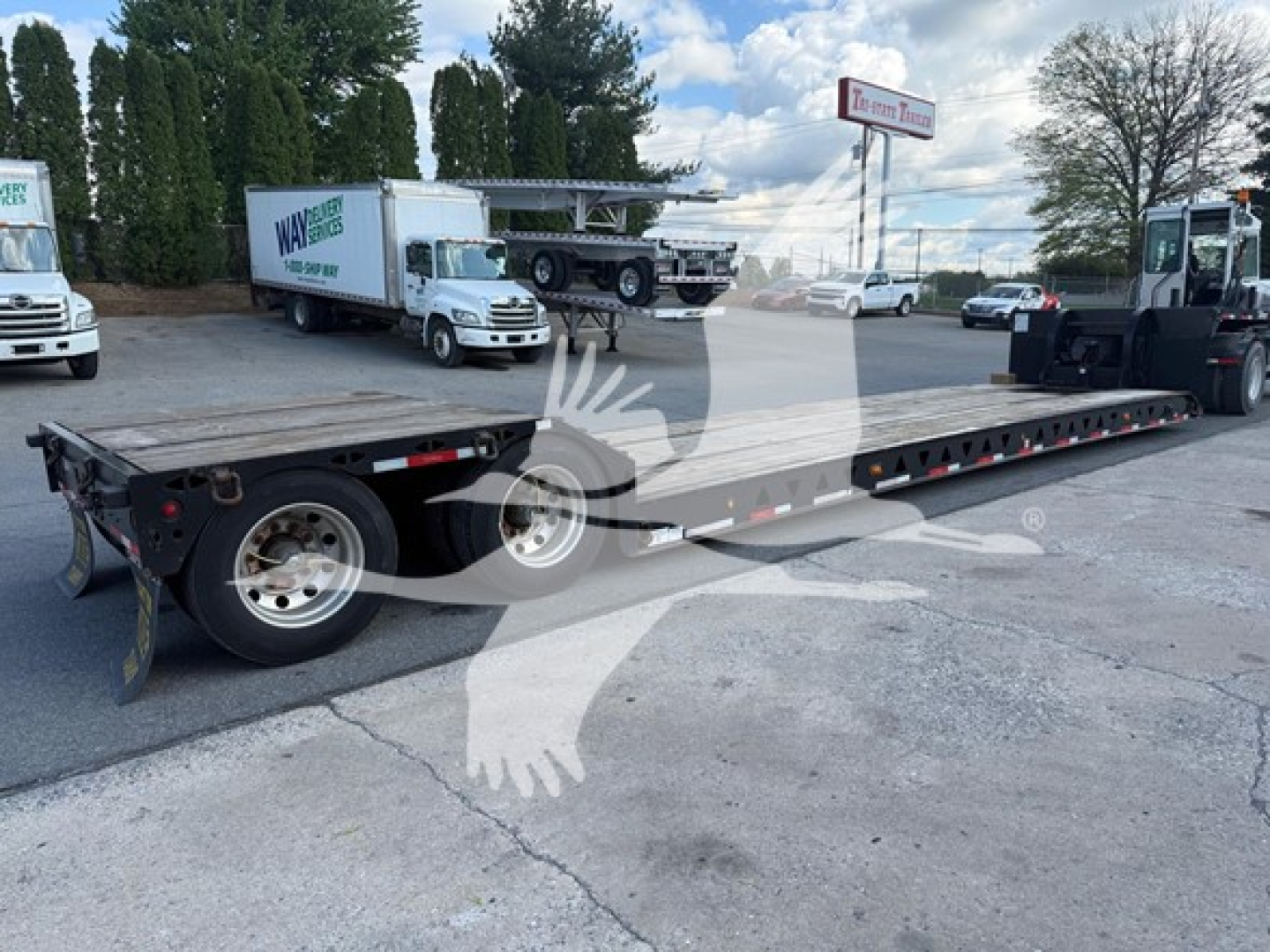 Talbert mechanical detachable lowboy trailer showing long flatbed with rear ramps and dual rear axles in a used condition.