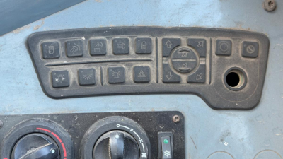 Kalmar DCG160-6T control panel with multiple switches and a circular joystick, inset into blue equipment surface.