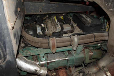 Kalmar DCG160-6T truck lifting equipment engine bay with hoses, cables, and badge area visible.