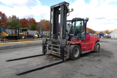 Kalmar DCG160-6T forklift in yard with extended forks and operator cab, side view.