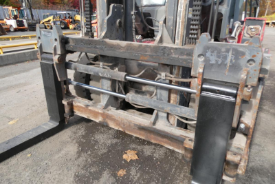 Kalmar DCG160-6T forklift carriage with hydraulic forks and tilt cylinders, metal frame, wear marks, in-service lifting equipment.