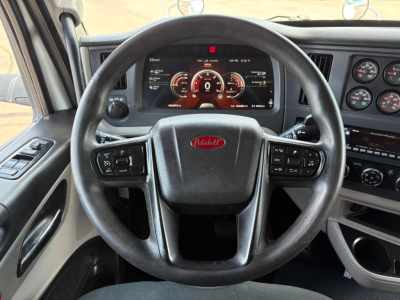 Peterbilt 579 interior steering wheel and dashboard with digital gauge cluster and steering wheel controls visible.