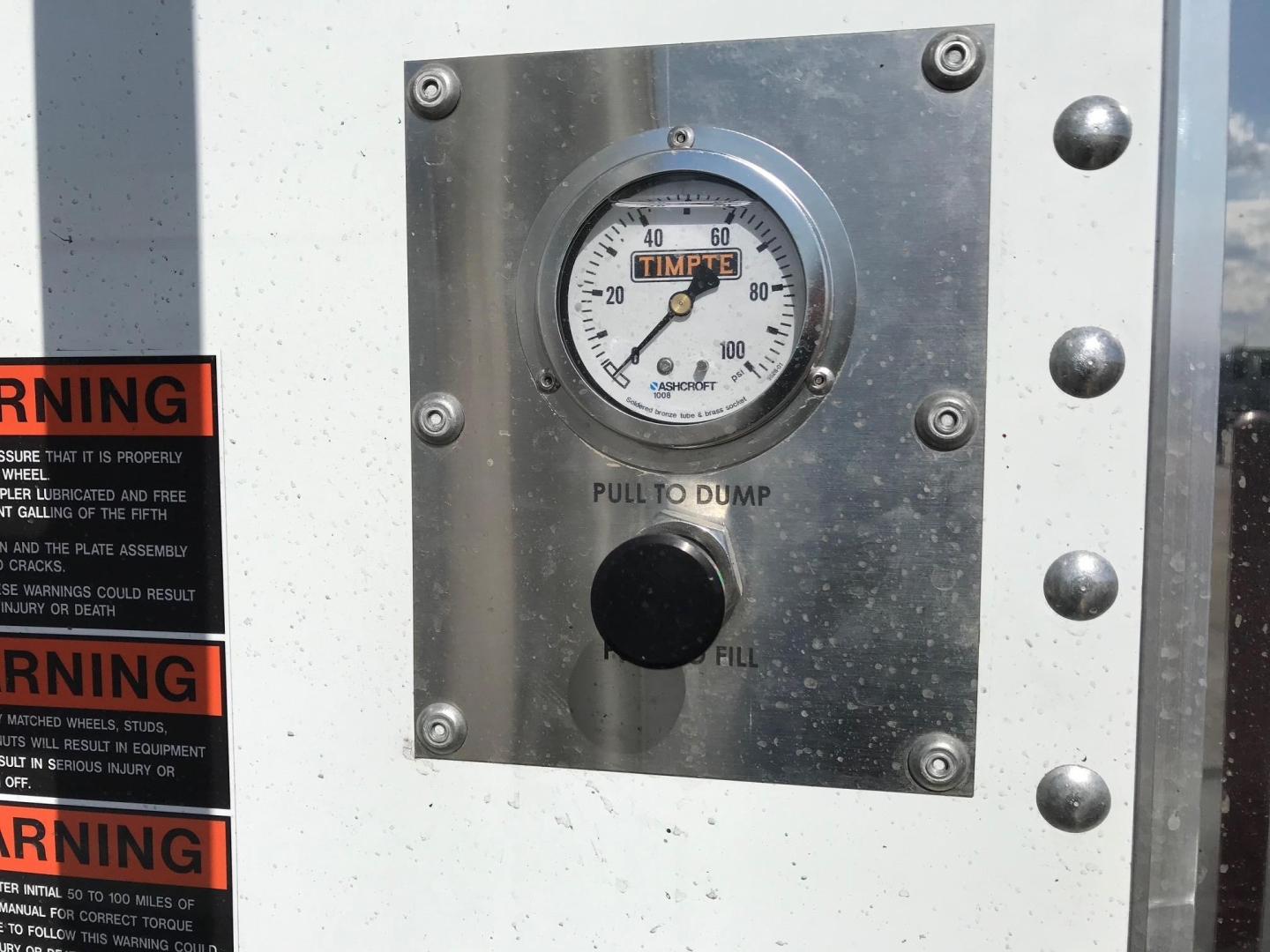 Timpte Super Hopper trailer control panel with fill and pull to dump gauge reading around 60-80 on scale.