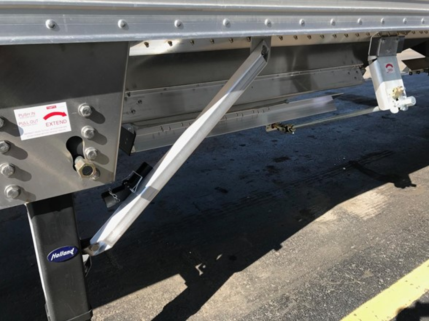 Timpte Super Hopper trailer side showing support brace and lower frame components with label stickers.