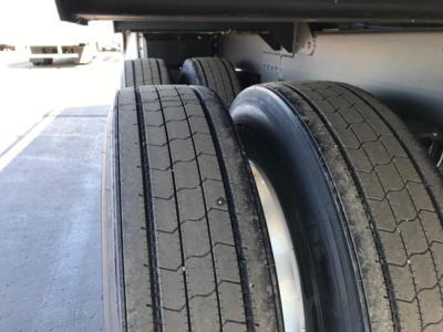 Trailer dual rear tires of a 2026 Timpte Super Hopper, showing twin drive wheels and wheel rims under the trailer frame.