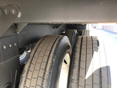 Timpte Super Hopper trailer wheel area showing dual tires and undercarriage components.