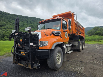 Dump truck 2020 Freightliner 114SD with orange dump body and front grille guard, side view.