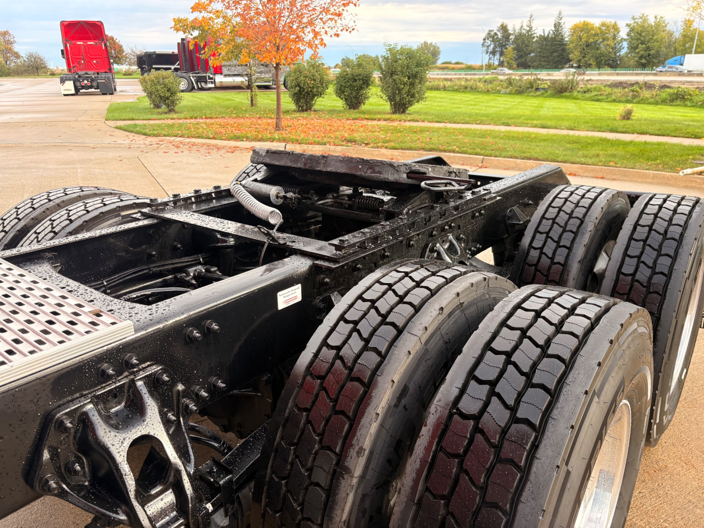 Kenworth T680 chassis and dual rear axles showing frame rails and suspension, with tires mounted on rims.