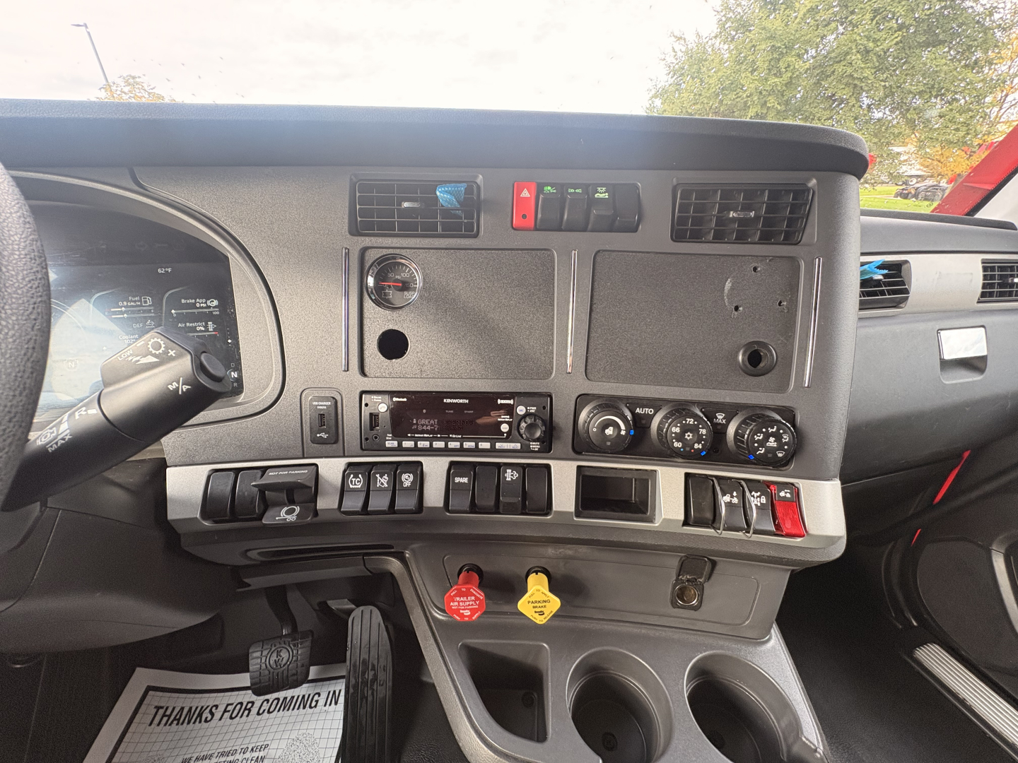 Kenworth T680 dash view showing instrument panel, controls, vents, and switches.