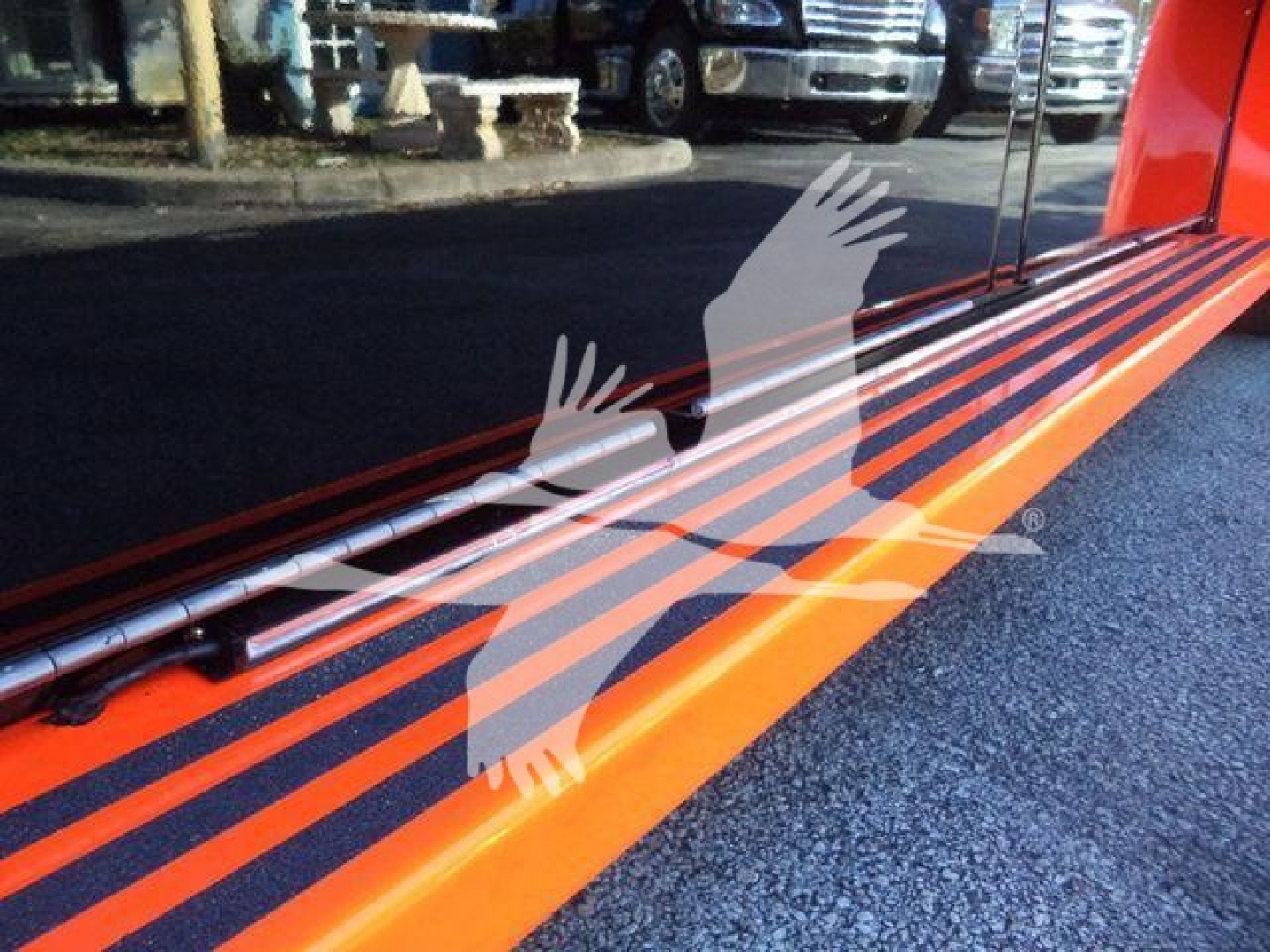 Side view of a bright orange Kenworth truck bed with a long metal rail and steps. Text visible includes stock/vehicle identifiers on the listing page overlay: 'Stock Number: EDGEDSTEPSIDEFM' and category/condition lines.