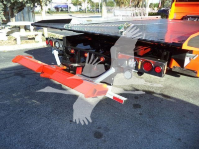 Kenworth T280 rollback truck rear showing platform and ramp with warning lights and reflective tape.