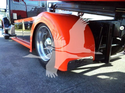 Kenworth T280 rollback truck rear wheel and fender with bright orange mud flaps and wheel well, chrome wheel, part of hydraulic system visible.