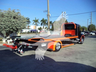 Kenworth T280 rollback tow truck shown from side-rear view with bright orange body and black accents.