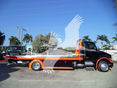 Kenworth T280 rollback truck side view showing orange and black color scheme with flatbed and hydraulic ramp.