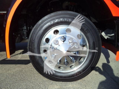 Wheel and front fender of a Kenworth T280 truck showing chrome wheel with multiple lug nuts and black tire, orange body panel above.