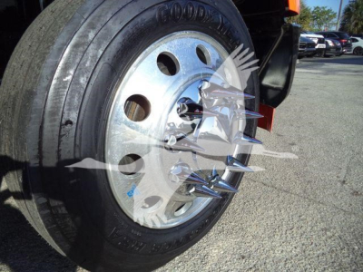 Truck wheel and tire showing Goodyear tire and polished steel rim with lug nuts visible.