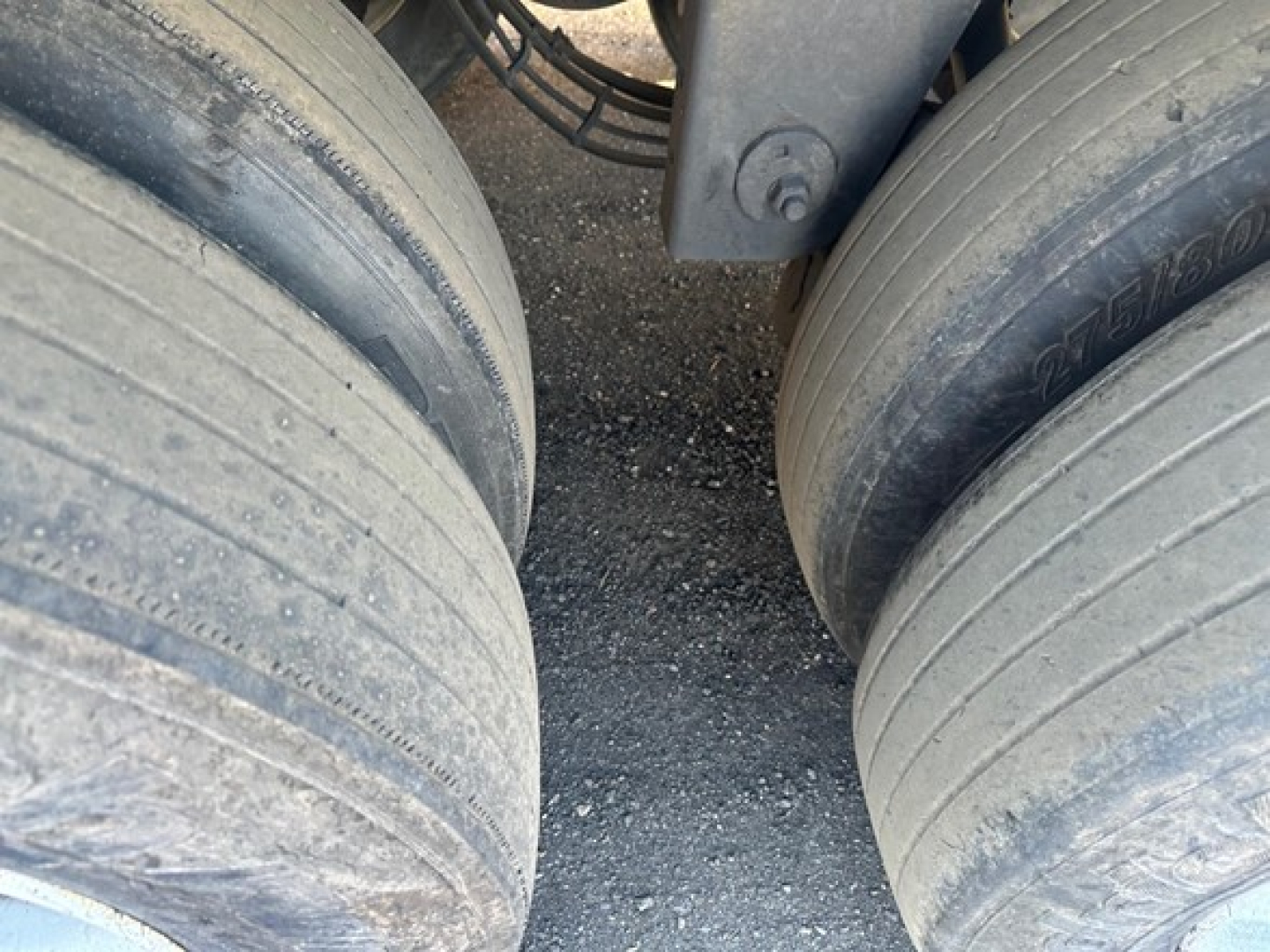 Rear wheels of a trailer showing twin axle tires with dirt and wear, part of a Hyundai air ride dry van trailer.