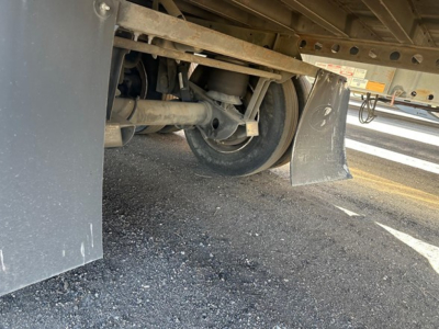 Trailer undercarriage view of a 2015 Hyundai air ride dry van showing wheel, suspension, and mud flap with some structural components visible.