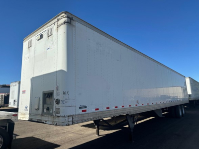 Trailer side view showing a white 2015 Hyundai Air Ride Dry Van with raised riveted panels and rear doors.