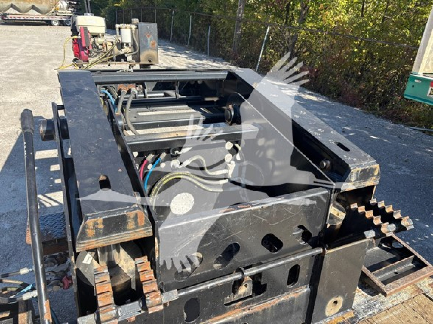 Trailer chassis in-view showing hydraulic and drive components with tracks at the sides and metal frame, 2016 XL Specialized XL80HDG lowboy trailer.