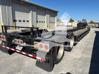 Trailer rear and side view showing XL80HDG lowboy trailer with dual rear axles, black frame, wooden deck, tail lights, and mudflaps. Visible license plate area and rear bumper.