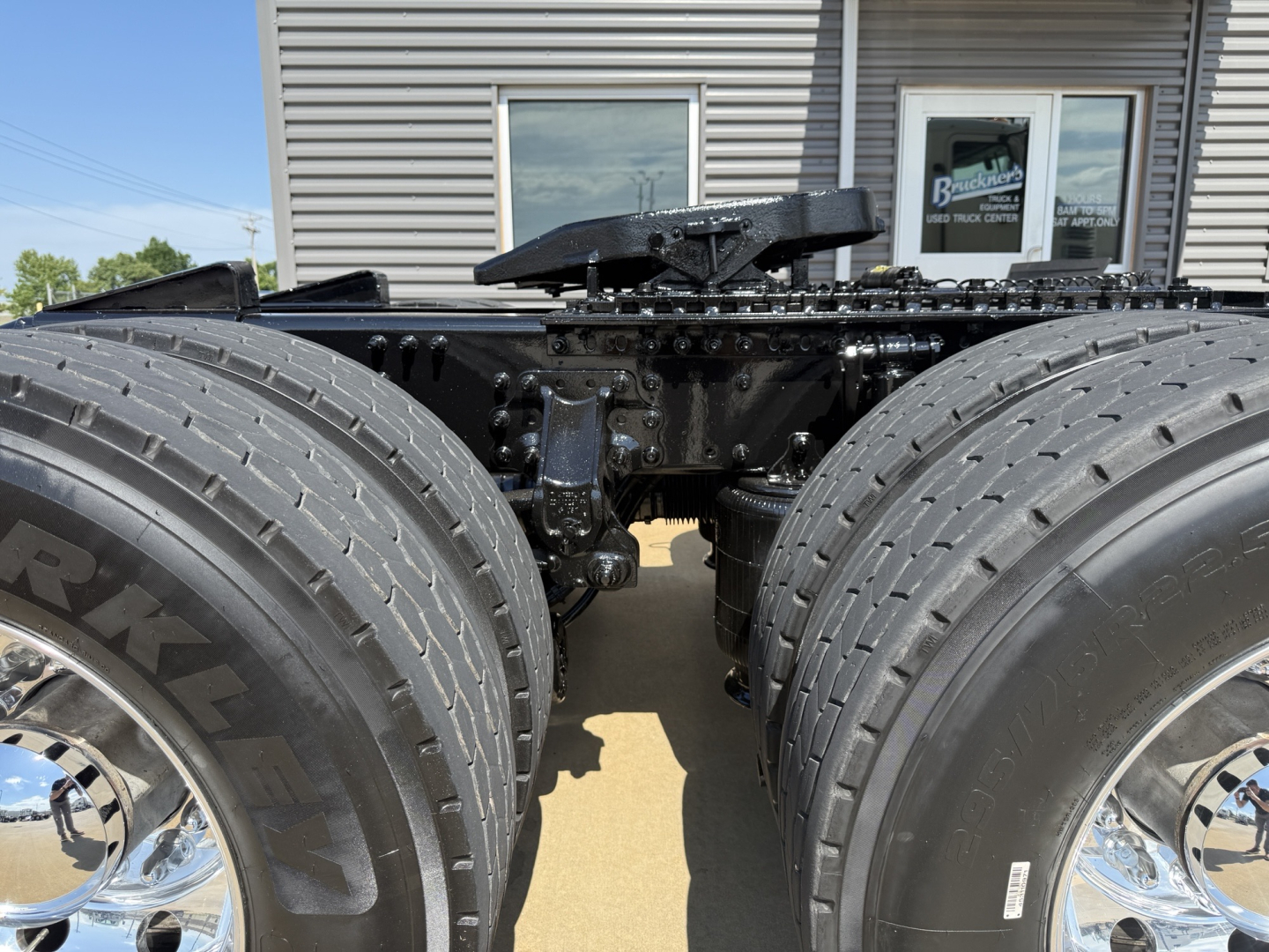 2020 Mack AN64T truck chassis view showing dual rear axles and heavy-duty tires; undercarriage with frames and suspension components visible.