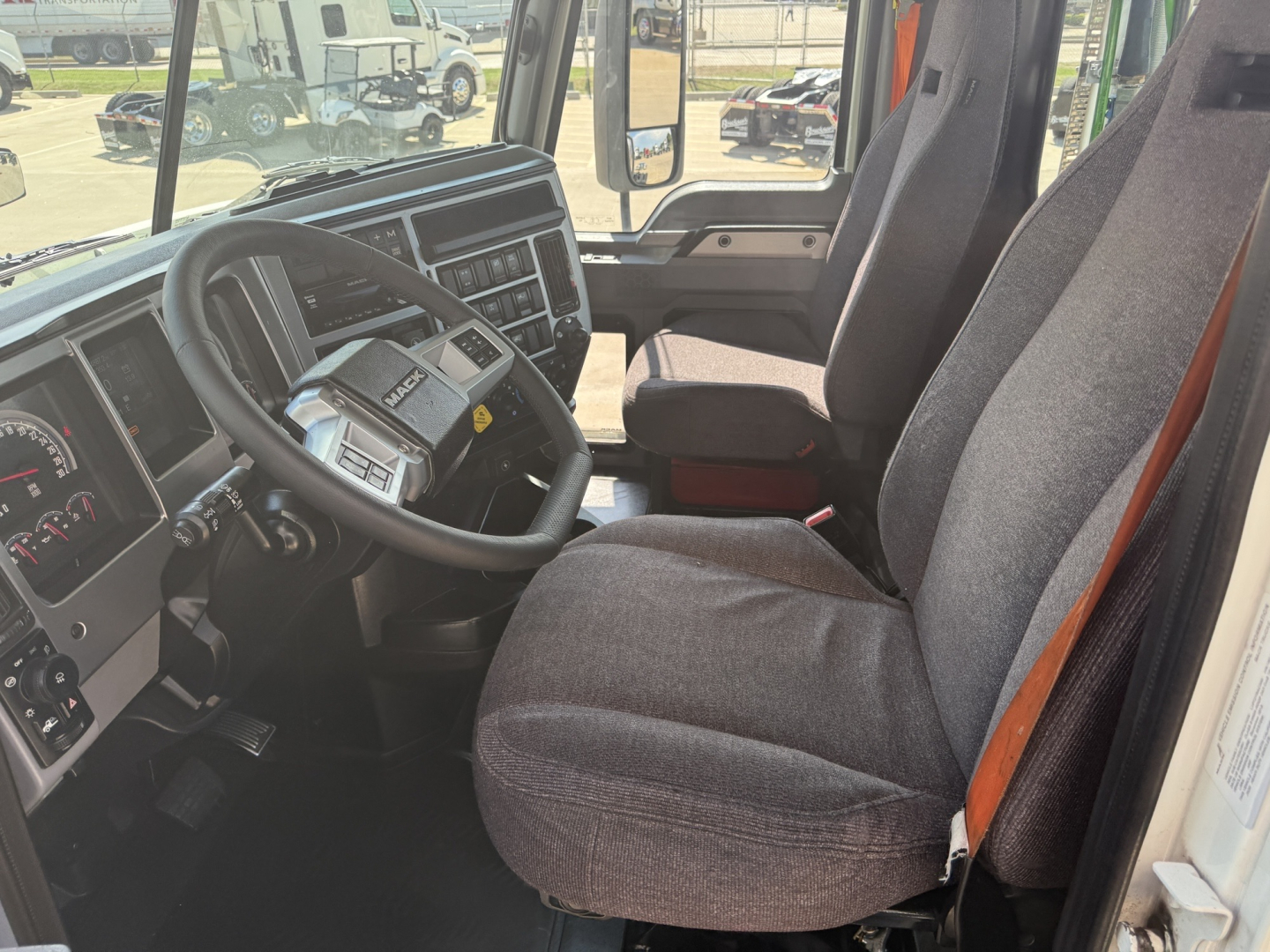 Cab interior of a 2020 Mack AN64T Daycab showing steering wheel, dashboard, and front seat.