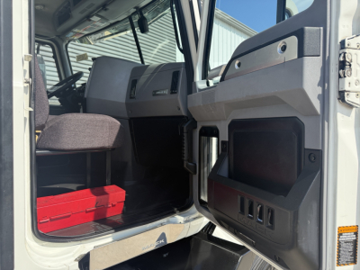 Truck cab interior of a 2020 Mack AN64T with open door showing seats, steering wheel, and dashboard area.