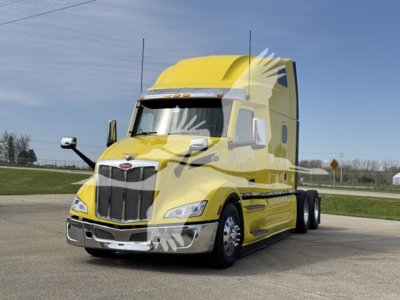 Peterbilt 579 conventional sleeper truck in yellow, side view showing front grille, headlights, chassis, and dual rear axles.