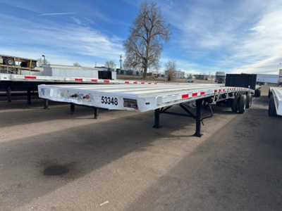 Flatbed trailer showing aluminum deck with 53' length and dual axles; image includes rear end with plate 53348 and landing gear visible.