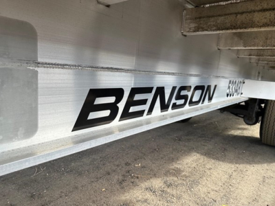 All-aluminum Transcraft flatbed trailer side with BENSON branding and serial/ID numbers visible.