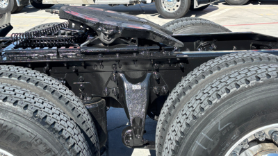 Tractor truck chassis showing rear bogie suspension and dual rear tires in a used 2021 International LT625 listing.