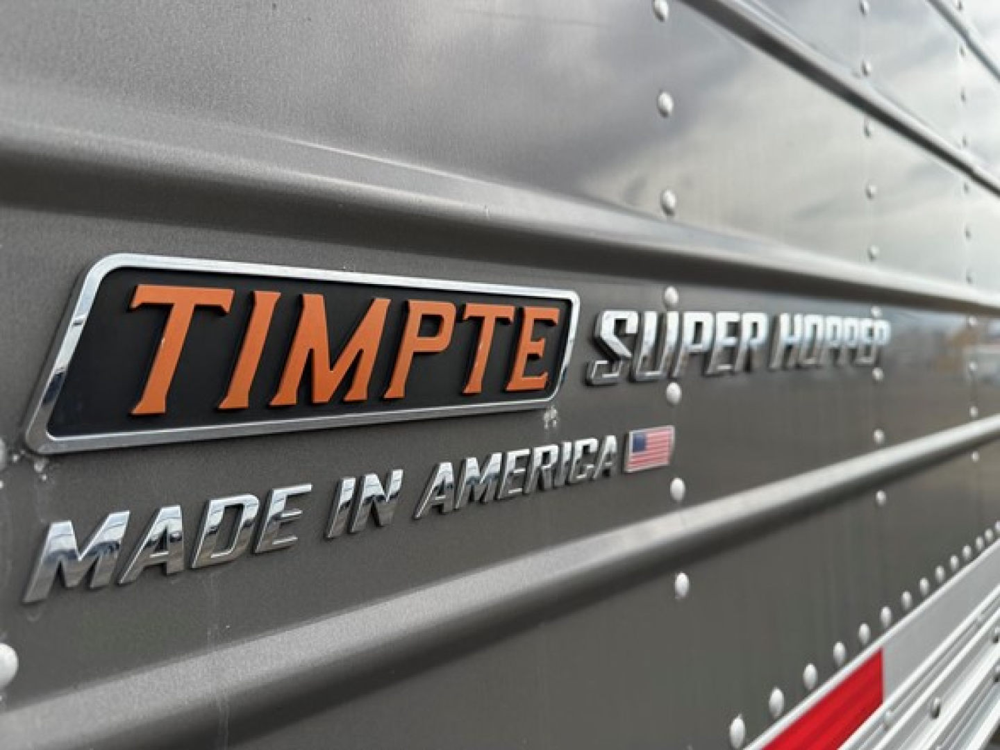Timpte Super Hopper trailer side with MADE IN AMERICA badge and Timpte logo visible