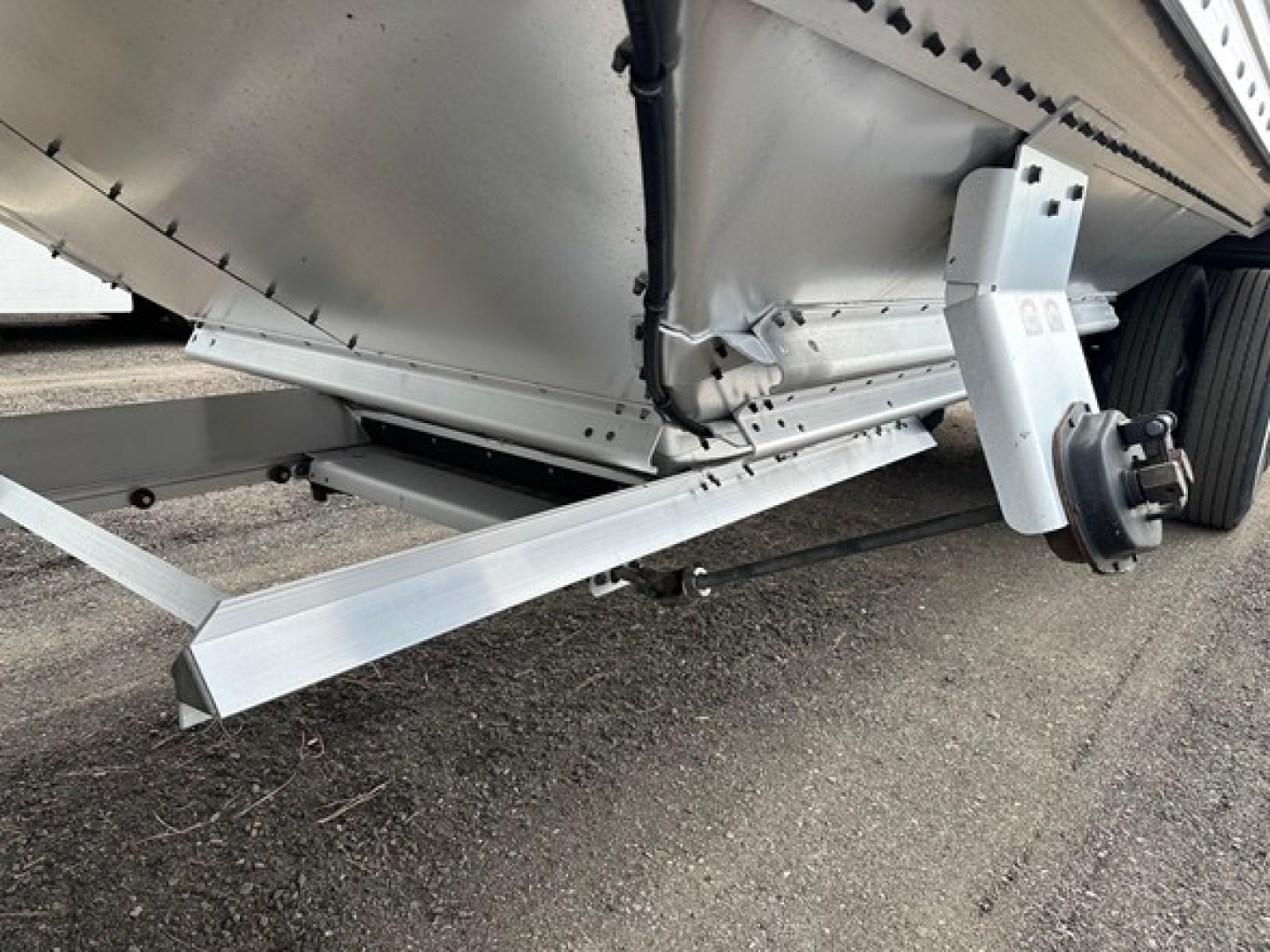 Timpte Super Hopper trailer side view showing lightweight aluminum side panel and undercarriage components.
