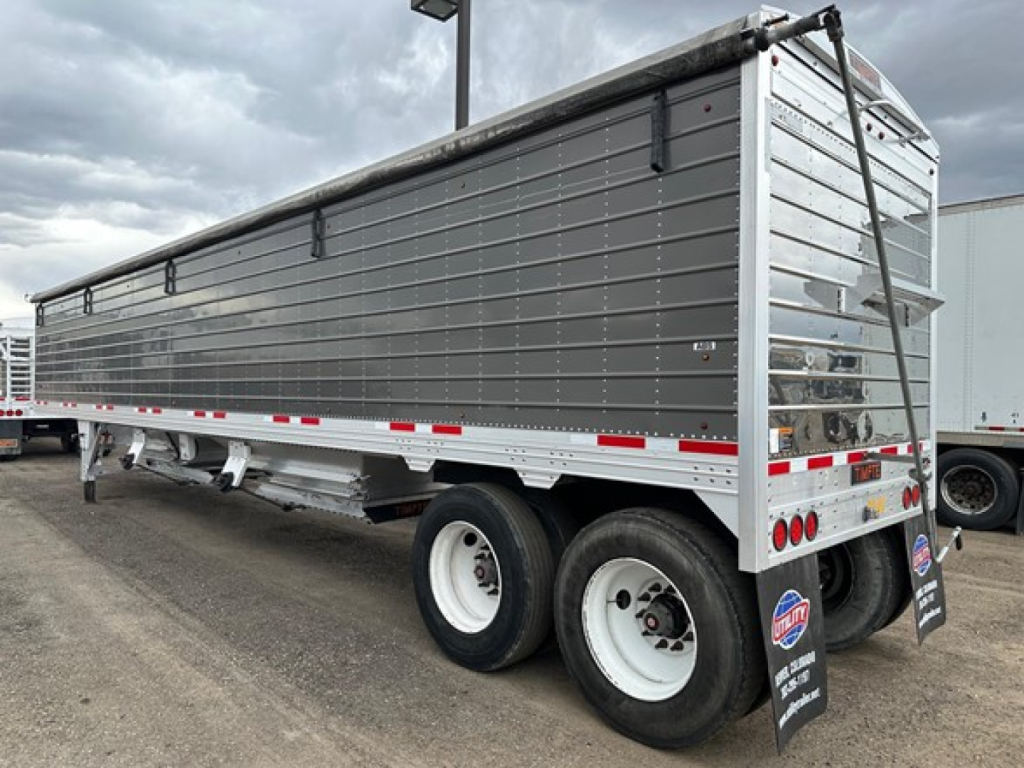 Timpte Super Hopper trailer in side view showing gray side panels and dual rear axles.