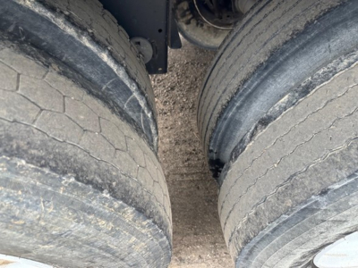 Two rear dual wheels of a 2024 Timpte Super Hopper trailer showing tread wear and mud on the tires.