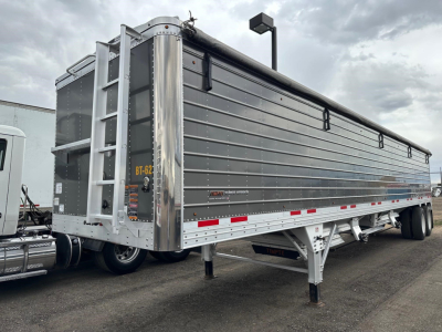 Timpte Super Hopper trailer with 78 inch sides, side view showing loading chute and ladder, gray aluminum panels, rear mud flaps, landing gear extended.
