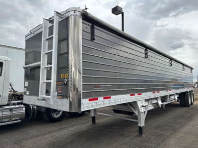 Timpte 2024 Super Hopper trailer side profile with ladder at rear, dual tandems, gray aluminum panels, reflective tape along lower edge.