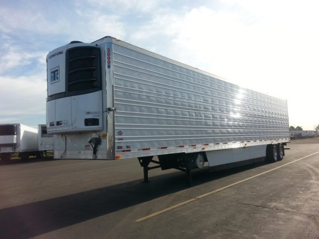 Trailer showing a 2026 Utility 3000R refrigerated trailer with TB branding on the front unit and ribbed aluminum side panels.