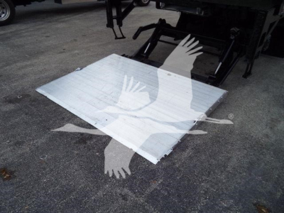 Flat aluminum ramp/step attached to back of truck with shadowed logo of a bird. No legible model text visible.
