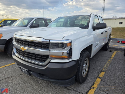 Chevrolet Silverado 1500 pickup truck in a parking lot, front-left view, white exterior with black grille and bumper, 4x4 badge visible.