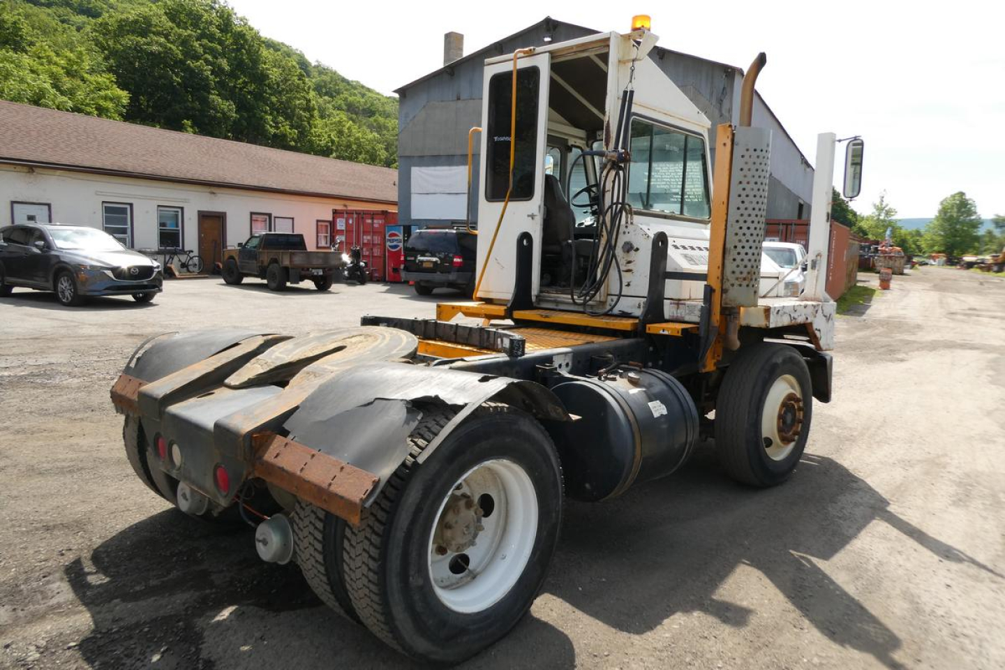 Kalmar Ottawa YT30 yard truck rear/driver side view showing cab, chassis, and coupling area with tires and rear deck.