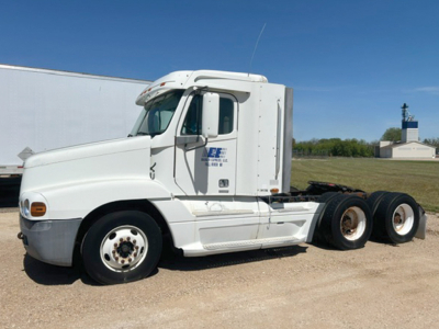 Truck cab side view of a white 2000 Freightliner C120 Century Class with sleeper aerodynamic top and logo on door.